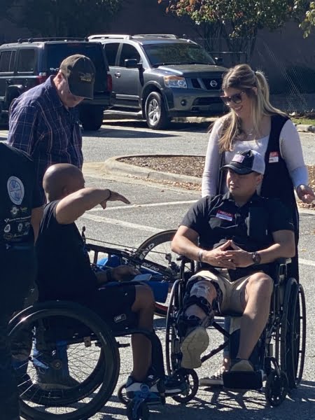 two people wheelchairs facing each other