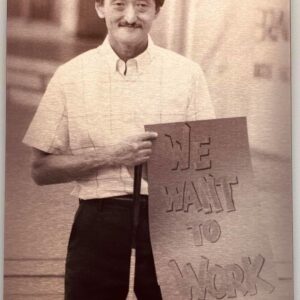 photo of a young man holding a sign for work