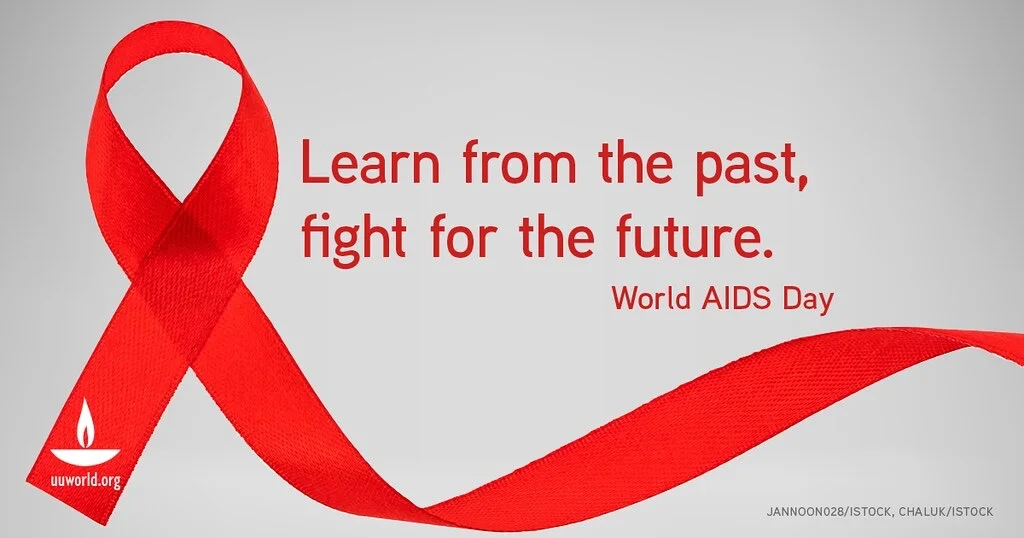 [A graphic with a gray background. On the left of the graphic is a red ribbon to represent World AIDS Day. To the right of the ribbon is two lines of red text that says, "Learn from the past, fight for the future." Below those lines of text is another line of text in a smaller font and aligned to the right. It says, "World AIDS Day.]